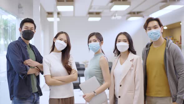 Portrait of Asian creative business team wears face mask