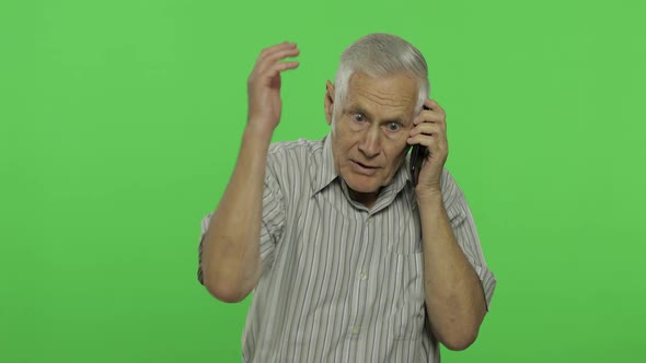 Senior Man Talks on a Smartphone. Handsome Old Man on Chroma Key Background alt