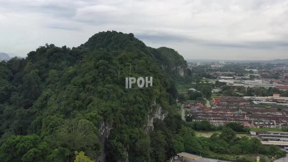 Panoramic aerial shot capturing busy highway traffics with iconic landmark of IPOH signage on top of alt