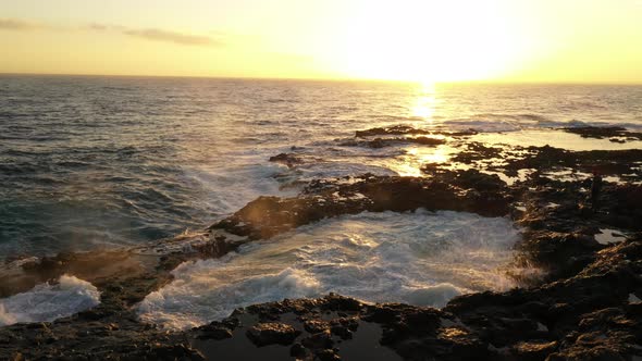 Man Exploring Coastline And Sunlit Waves alt