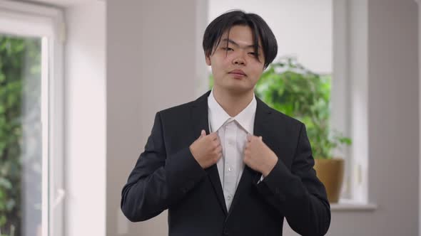 Mirror POV of Young Confident Happy Groom Adjusting Blazer Looking at Camera alt