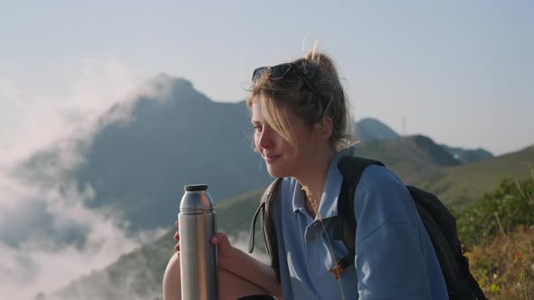 Happy Female Tourist on Top of Mountain at Summer alt