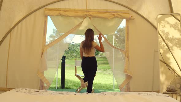 Travel Camping Woman Walks to Outside of Tent to View on Nature and Wild Animals alt