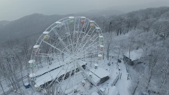 Ferris Wheel on Top of Mount Akhun During a Snowfall alt
