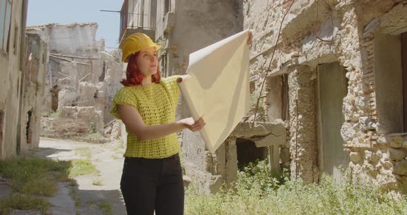Rescuer looks at a map of a city destroyed by the war in Ukraine alt