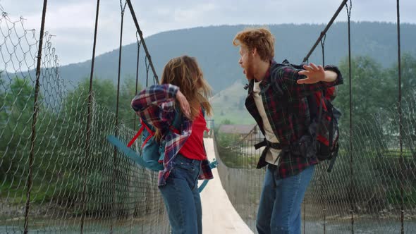 Two Hitchhikers Enjoy Jump on Mountains River Bridge alt