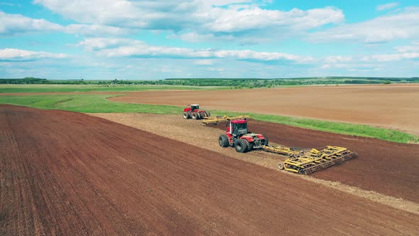 Agricultural Vehicles Are Sowing a Massive Field alt
