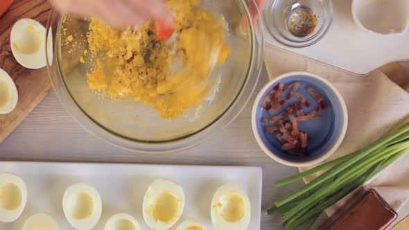 Preparing deviled eggs with organic eggs for appetizer. Step by step recipe. alt