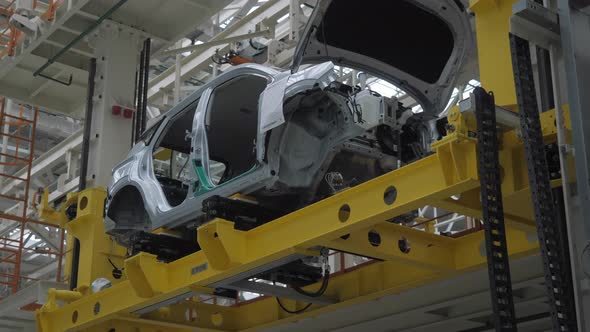 The Car Frame Moves Along the Conveyor Belt alt