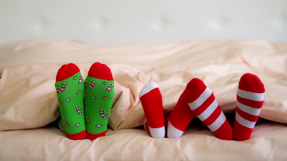 Family in Christmas Socks in Bed