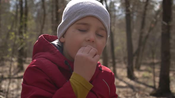 Boy Eating Cookies in the Forest, Close-up,slow-mo