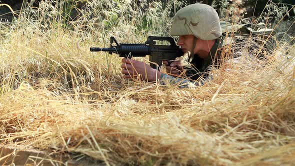 Military soldier during training exercise with weapon alt