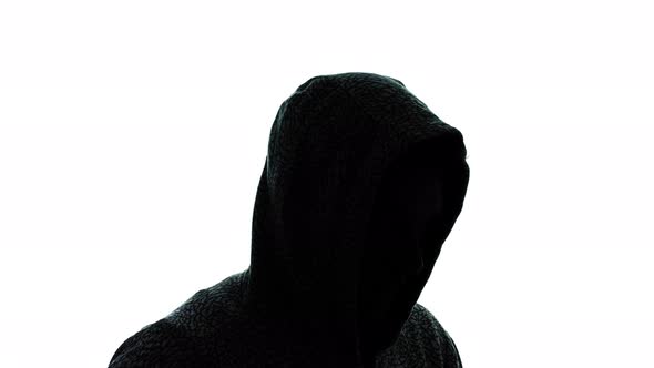 Mysterious Man in Silhouette with Hood on the Head Rotating