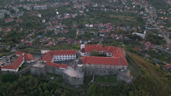 Aerial View of Medieval Castle on Mountain in Small European City at Cloudy Autumn Day alt