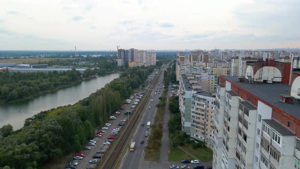 Aerial view of traffic on a street, a river and apartment buildings, in a old soviet district, overc alt
