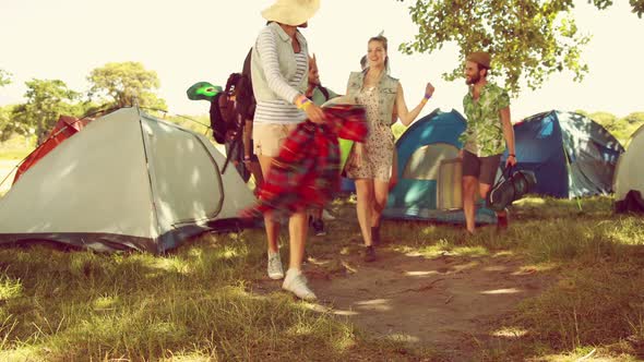 In high quality 4k format excited friends arriving at music festival alt