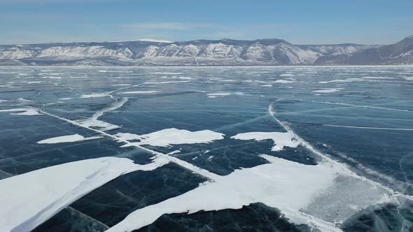 4k. Blue Ice of Baikal lake from the sky in winter.