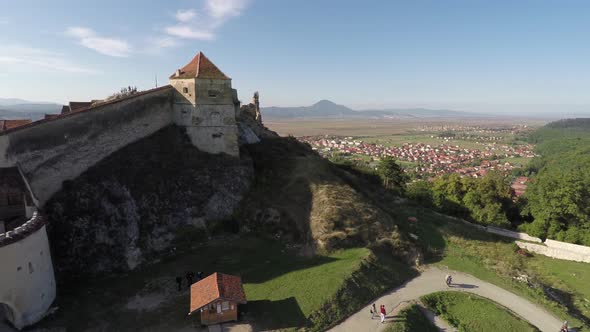 Aerial view of Rasnov Citadel on top of a hill alt