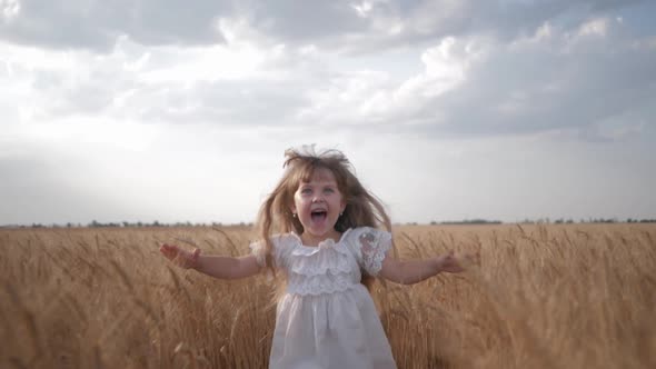 Child in Field, Emotional Little Girl in White Dress Runs with Arms Spread To Meeting To Across alt