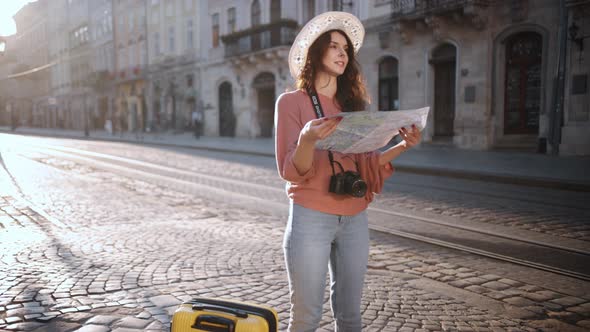 Slow Motion Hipster Girl Holds Tourist Map Enjoying Vacation Lady Walking Down Street Looking Way alt