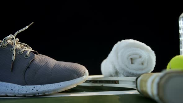 Water bottle, sports shoes and sports equipment in tennis court 4k alt