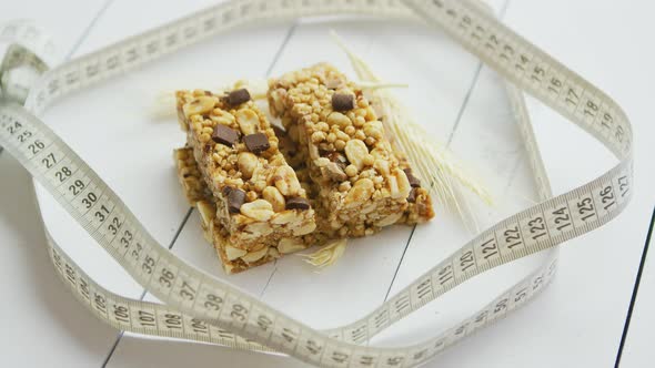 Granola Bars with Dried Fruits Wooden Background alt