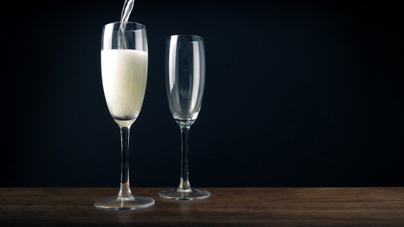 Champagne Is Poured Into Couple Of Elegant Glasses alt