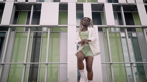 Stylish Young African American Woman Dancing Hip Hop Street Dance Outdoors alt