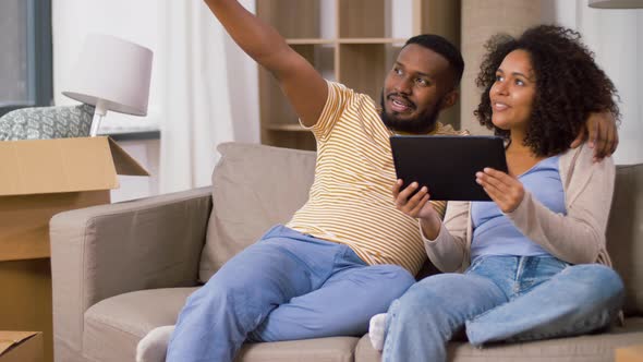 Happy Couple with Tablet Pc Computer at New Home alt