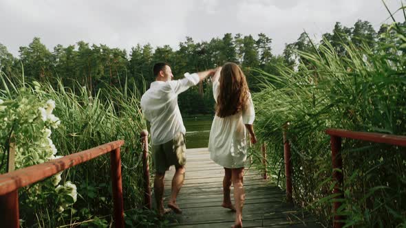 Sweat Couple Running on the Bridge in Forest