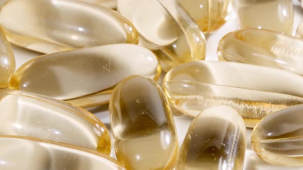Macro Shot of a Yellow Oil Capsules Vitamin C Omega 3 Rotating Closeup alt