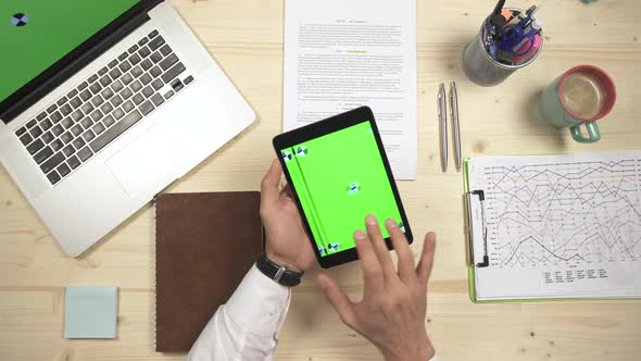 Fingers sliding on a tablet at work alt