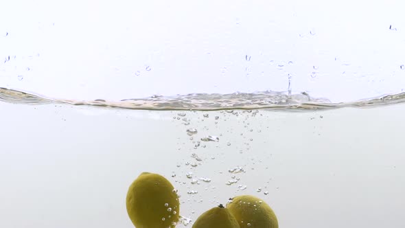 Bright Juicy Lemons Falling in Water, Refreshing Lemonade Ingredient, Vitamin C alt