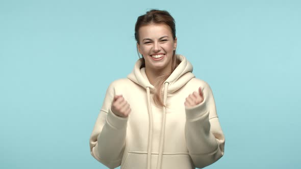 Slow Motion of Attractive Young Woman Feeling Joy Making Fist Pump and Celebrating Laughing Carefree