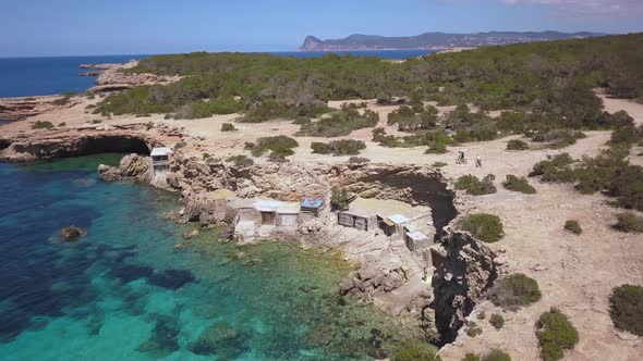 Exploring the breathtaking beach in Ibiza on mountain bike, drone aerial alt