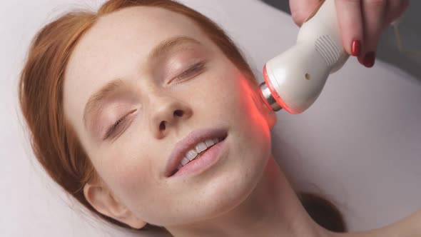 Happy Woman Receives a Hardware Phonophoresis Procedure From a Cosmetologist in a Spa Salon alt