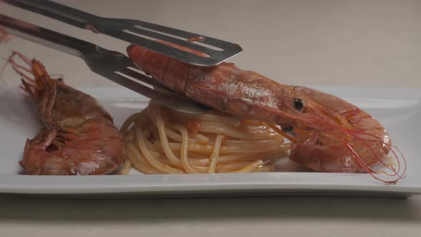 Home cooking gourmet red shrimp on Italian spaghetti pasta. Delicious dish plate of cooked shrimp pr alt