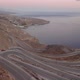 Aerial drone 4K footage of a curved rocky road. Motorway through mountains next to a precipice - VideoHive Item for Sale