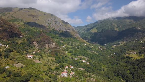 Aerial View of Mountain Gorge Hills Covered with Green Forest. Italian Landscape Sunny Weather