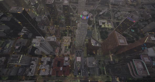 Dark helicopter aerial of Los Angeles cityscape during firework show, night