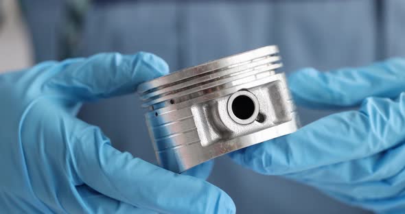 Auto Mechanic Checks Automobile Engine Piston alt