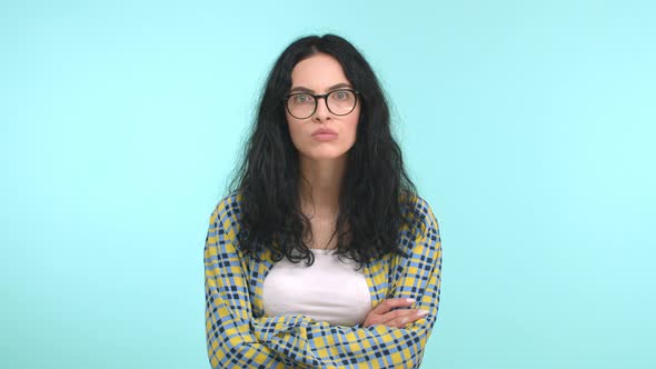 Young Attractive Woman with Long Dark Hair and Glasses Staring Serious and Pensive at Camera alt