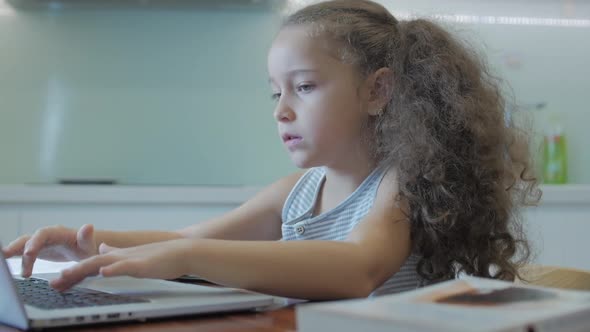 Little Girl a Cute Elementary School Child of 7-8 Years Old at Home Studying in Family Learning alt