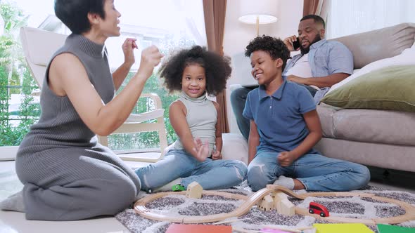 Full length of a happy African American family is enjoying in living room on weekend.