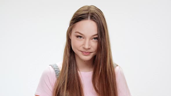 Shy Young Beautiful Girl Smiling Over White Background alt