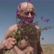 Motion Around Satisfied Old Man Smelling Flowers on Field - VideoHive Item for Sale