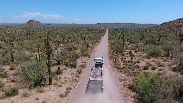 Loading transfer truck leaving a rock quarry alt
