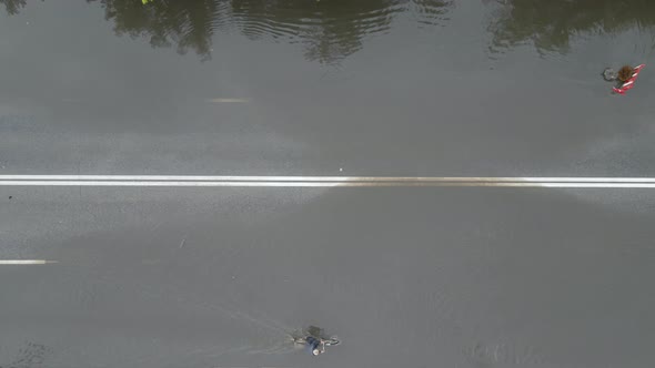 Aerial View of City Traffic with Cars Driving on Flooded Street After Heavy Rain alt