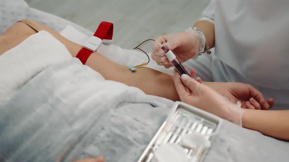 Nurse Taking a Blood Sample From a Patient Lying in a Hospital Ward alt