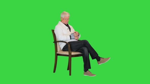Senior Man Succeeds in Lowering His Blood Pressure on a Green Screen Chroma Key alt